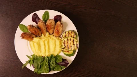 Plate of fried chicken, mashed potatoes on table Zucchini on a plate enhances Stock Footage 270367538