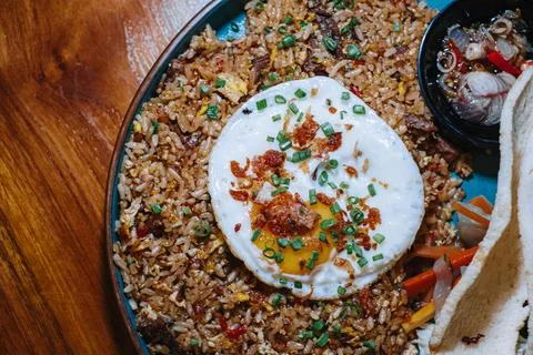 A plate of fried rice with additional egg and typical indonesian cracker Stock Photos