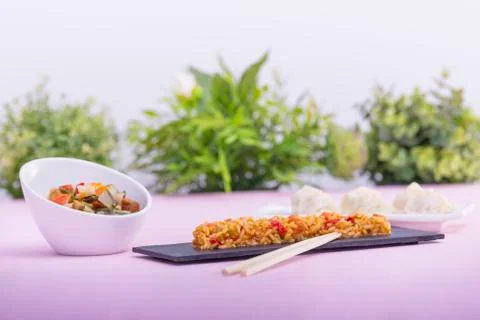 Plate of fried rice with assorted vegetables and dumplings Stock Photos