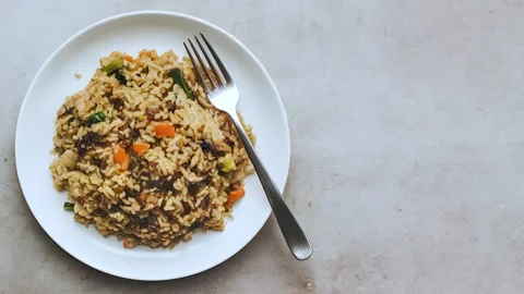 Plate of fried rice with vegetables and meat top view Stock Footage 288996189