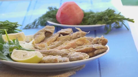 Plate of fried small fish red mullet with arugula and lemon, close up view. Stock Footage 80305822