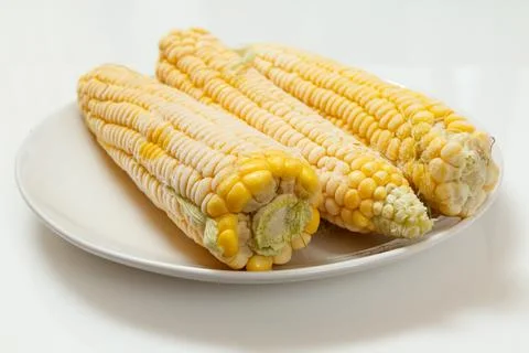 Plate with frozen corn on plate with white background Stock Photos