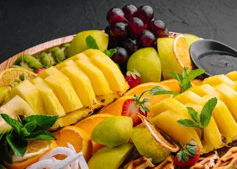 A plate of fruit assorted on black stone Stock Photos