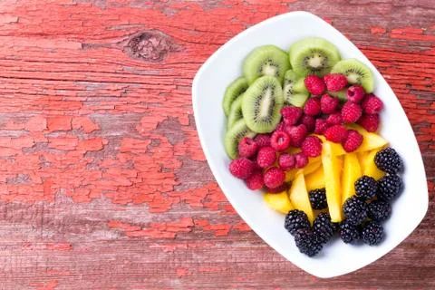 Plate of fruit on old table Stock Photos