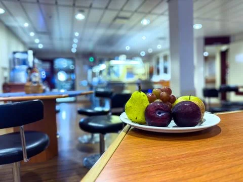 A Plate of fruit on the table with a blurred background. Stock Photos