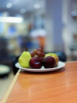 A Plate of fruit on the table with a blurred background. 스톡 사진