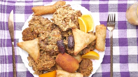 Plate full of appetizing fried snacks with orange slices and dates served o.. Stock Footage 332475338