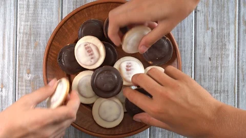 Plate full of biscuits with glaze being snatched up by five hungry children Stock Footage 93692926