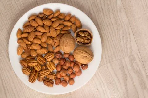 Plate full of nuts Stock Photos
