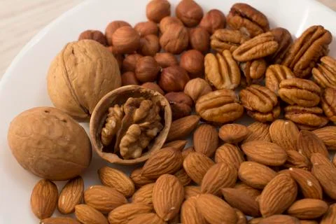 Plate full of nuts Stock Photos
