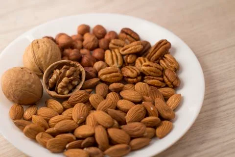 Plate full of nuts Stock Photos