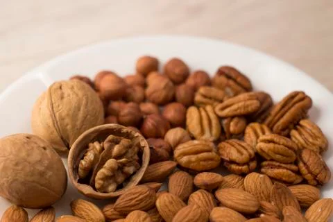 Plate full of nuts Stock Photos