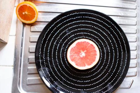 Plate with half grapefruit Stock Photos