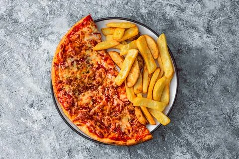 Plate with half pizza half chips Stock Photos