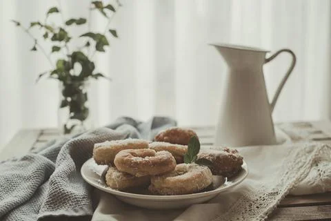 Plate of homemade donuts on a table by a window Stock Photos