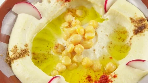 Plate with hummus made in restaurant, appetizer made from mashed chickpeas Stock Footage 75672911