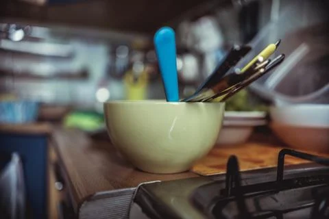 The plate is on the kitchen table and in it lay a clean spoon and fork 스톡 사진