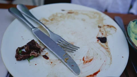 Plate leftovers, finished plate, Dining Aftermath Empty Plate with Meal Resid Stock Footage 247699146