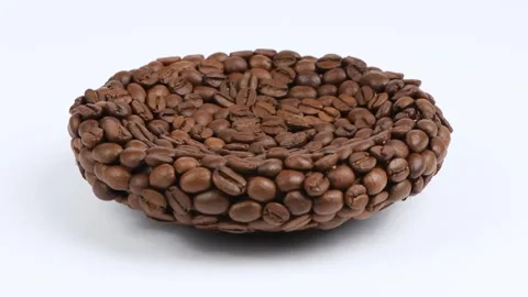 A plate made of coffee beans on white. Side view. Loop motion. Rotation 360 Stock Footage 245079220