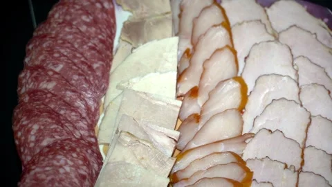 A plate of meat and cheese with a slice of pepperoni Stock Footage 306960489