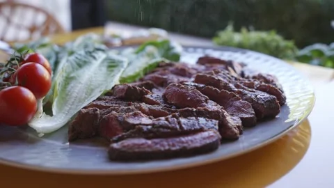 A plate of meat and vegetables, including tomatoes, lettuce Stock Footage 297872047