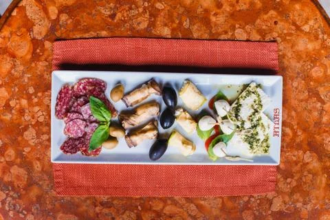 The plate with meat, different types of cheese and olives are decorated with Stock Photos