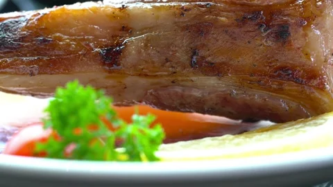 A plate of meat with a fork and knife on it Stock Footage 313357155