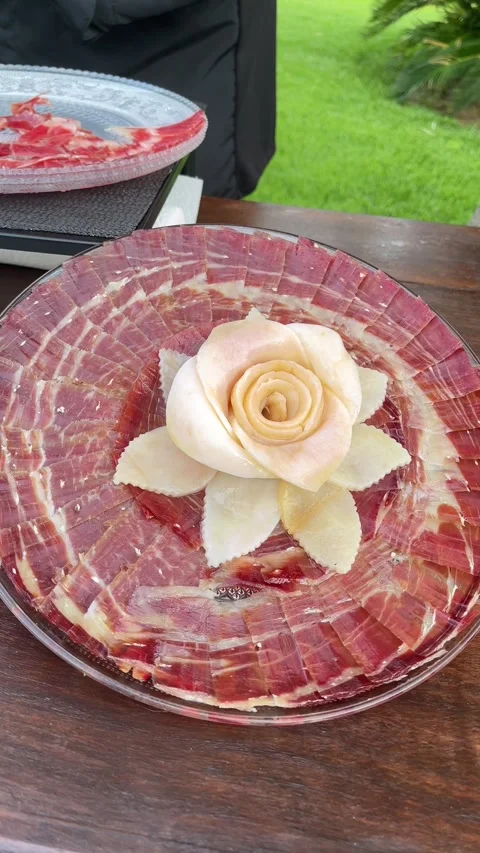 A plate of meat with a rose on it Stock Footage 278034736