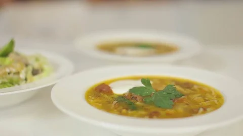 A plate of meat soup and a light summer salad from Peking cabbage. Dolly cam Stock Footage 78684089