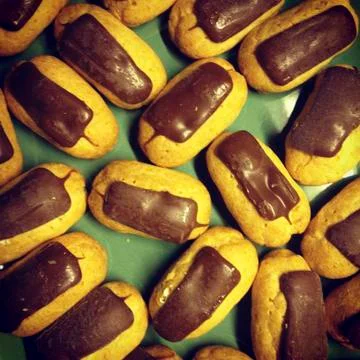 A plate of mini chocolate eclairs Stock Photos