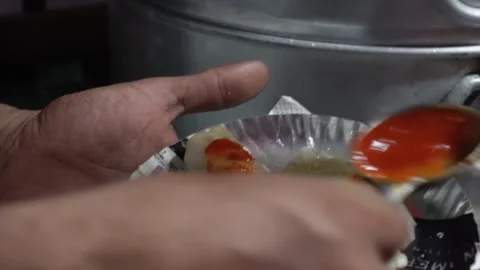 Plate of momos adding sauce Stock-Footage 326342494