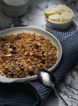 Plate of a muesli with chocolate and raisins and bananas Stock Photos