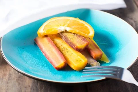Plate of multi colored carrots with orange sauce Stock Photos