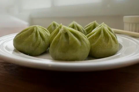 A plate of multiple green Dim Sum dumplings Stock Photos