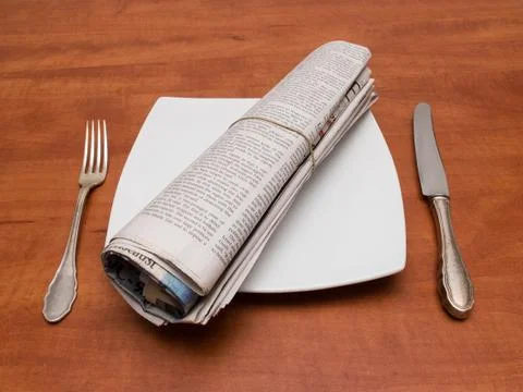 Plate with newspaper. Stock Photos
