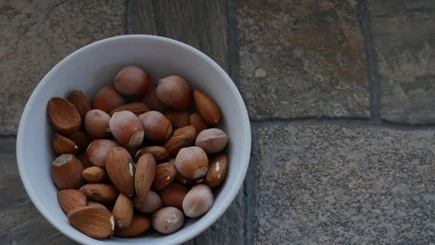 Plate with Nut Mix on a Stone Surface. Almonds and Hazelnuts Macro. Nuts Detail Stock Footage 118703033