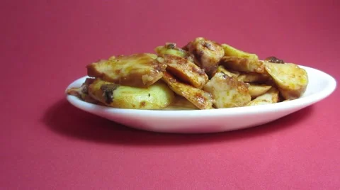 Plate of octopus with paprika on red background Stock Footage 57053443