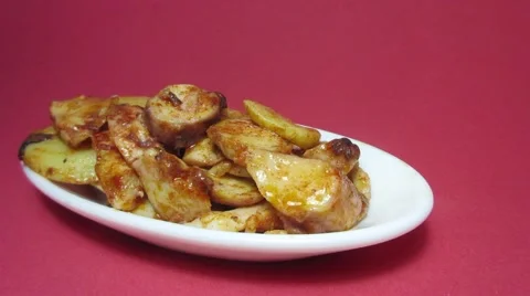 Plate of octopus with paprika on red background Stock Footage 57055173