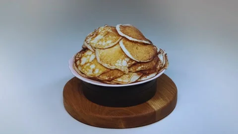 A plate of pancakes rotates on the table Stock Footage 169666663