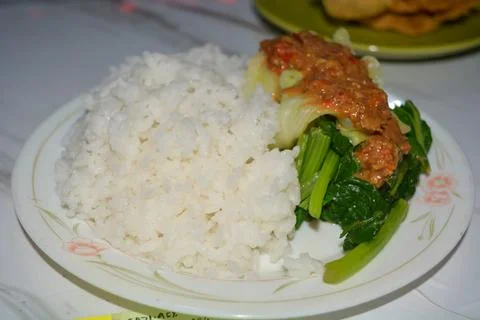 A plate of pecel rice, on a white background. Stock Photos