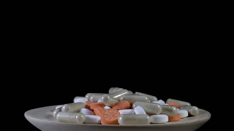 A plate with pills in slow motion Stock Footage 153095483