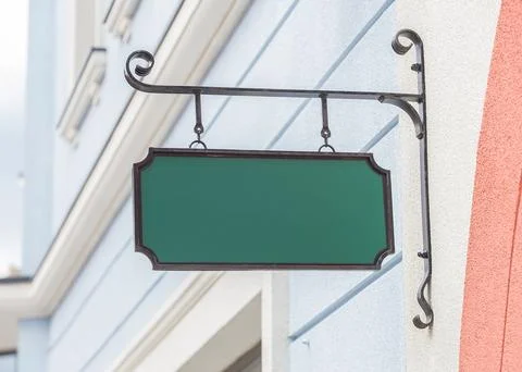 Plate with place for text on the bracket on the facade Stock Photos
