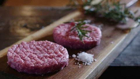 Plate preparation of meat, beef raw burgers placed on wood Stock Footage 81050329