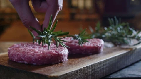 Plate preparation of meat, beef raw burgers placed on wood Stock Footage 81050587