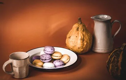 A plate with pumpkin-flavored macaroons. Cooked homemade cookies with rustic Stock Photos