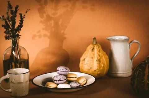 A plate with pumpkin-flavored macaroons. Cooked homemade cookies with rustic Stock Photos