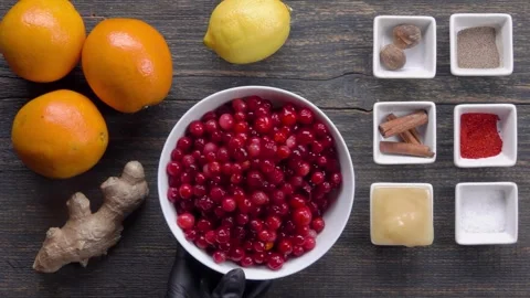 A plate of raw cranberries is placed on the table with the ingredients Video stock 302214576