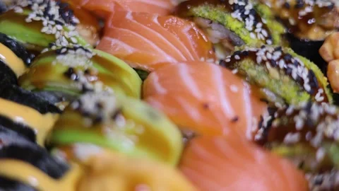 Plate of raw fish roll, salmon sushi with sesame rotate on tray Stock Footage 314505952