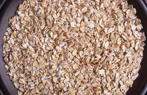 Plate with raw oatmeal background Stock Photos