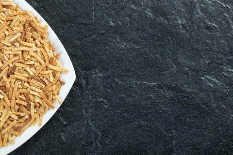 Plate of raw pasta on dark background Stock Photos
